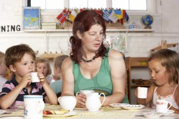 Royalty Free Photo of Children and a Teacher at Playschool