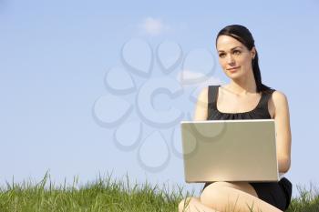 Royalty Free Photo of a Woman With a Laptop Outside