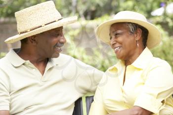 Royalty Free Photo of a Couple Outside Wearing Straw Hats