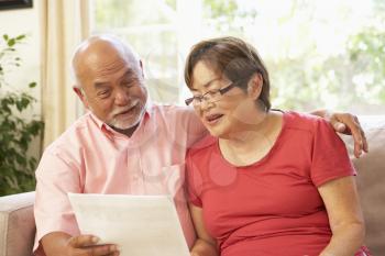 Royalty Free Photo of a Couple Reading a Paper