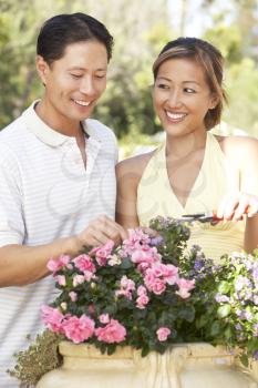 Royalty Free Photo of an Asian Couple With a Flower