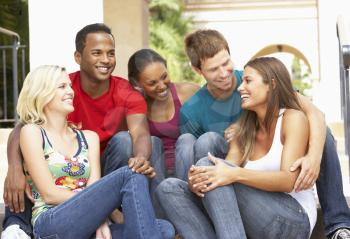 Royalty Free Photo of a Group of People Sitting on Steps