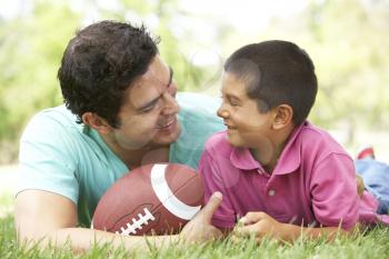 Royalty Free Photo of a Father and Son With a Football