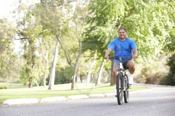 Royalty Free Photo of a Man Riding a Bike