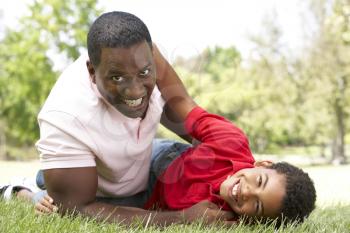 Portrait of Happy Father and Son In Park