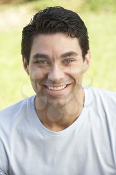 Portrait Of Young Man Sitting In Park