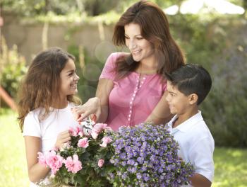 Mother And Children Gardening Together