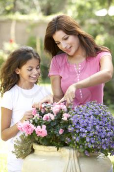 Mother And Daughter Gardening Together