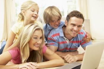 Family Using Laptop At Home Together