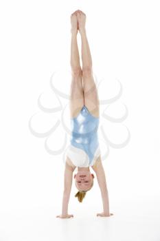 Studio Portrait Of Young Female Gymnast Doing Handstand