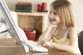 Young Girl Using Computer At Home