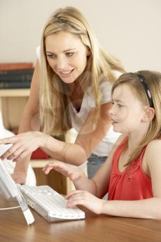 Mother And Daughter At Home Using Computer