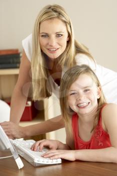 Mother And Daughter At Home Using Computer