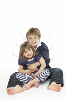 Studio Portrait Of Happy Brother And Sister