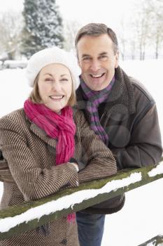 Senior Couple Standing Outside In Snowy Landscape