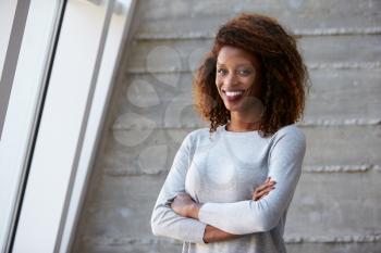African American Businesswoman Standing Against Office Wall