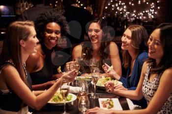 Group Of Female Friends Enjoying Meal In Restaurant