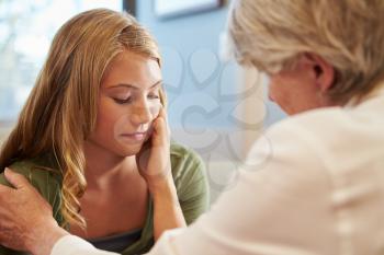 Doctor Treating Teenage Girl Suffering With Depression