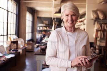 Portrait Of Female Owner Of Gift Store With Digital Tablet