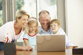 Family Using Laptop At Home