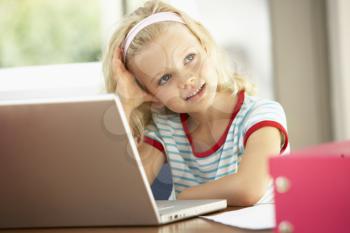 Young Girl Using Laptop At Home