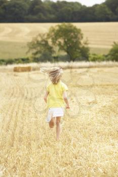 Girl Running Through Summer Harvested Field
