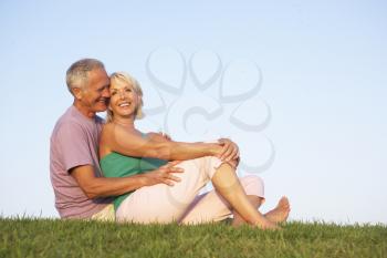 Senior couple posing on a field