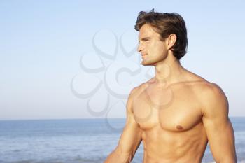Young man poses on beach