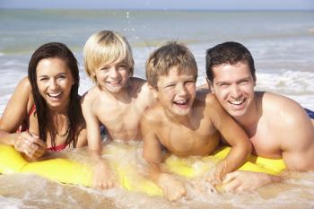 Young family pose on beach