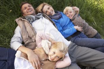 Young family lying together on grass