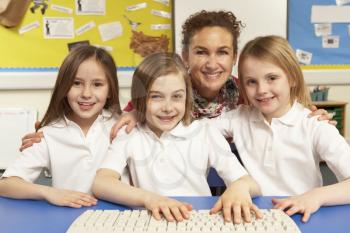 Schoolchildren in IT Class Using Computers With Female Teacher