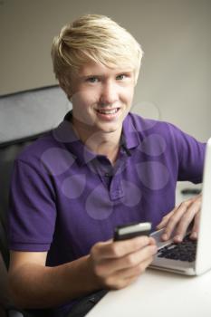 Teenage Boy Lying  In Bedroom Drinking