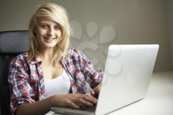 Teenage Girl Using Laptop At Home