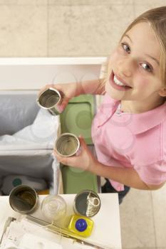 Young Girl Recyling Waste At Home