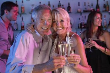 Senior Couple Having Fun In Busy Bar