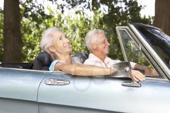 Senior couple in sports car