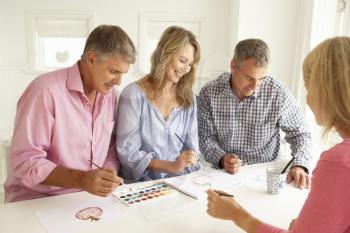 Mid age couples painting with watercolors