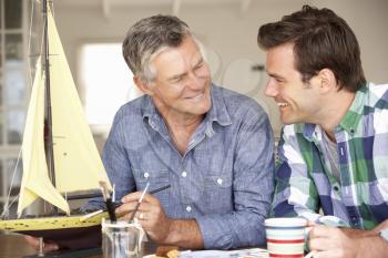 Adult father and son model making