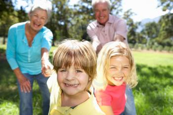 Senior couple on country walk with grandchildren