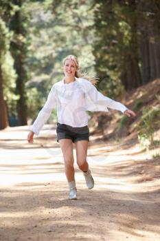 Woman running along country lane