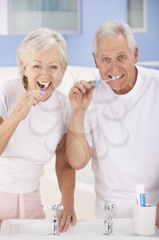 Senior couple brushing teeth