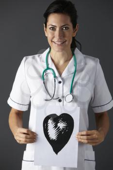 American nurse holding ink drawing of heart
