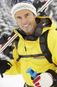 Middle Aged Man On Ski Holiday In Mountains