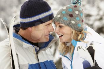 Middle Aged Couple On Ski Holiday In Mountains