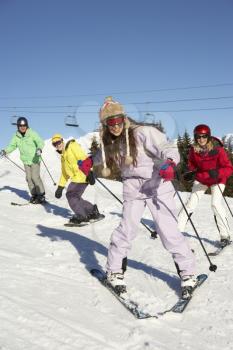 Teenage Family On Ski Holiday In Mountains