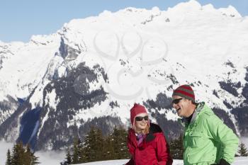 Couple Having Fun On Ski Holiday In Mountains