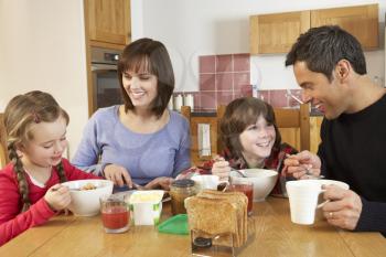 Family Eating Breakfast Together In Kitchen