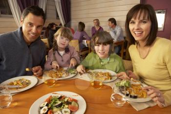 Family Eating Lunch Together In Restaurant