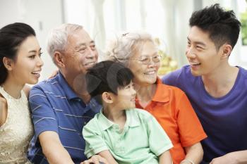 Portrait Of Multi-Generation Chinese Family Relaxing At Home Together