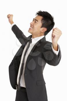 Studio Portrait Of Chinese Businessman Celebrating